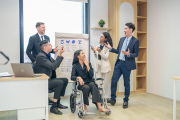 corporate diverse business people and business person with disability meeting, discussing,analysis new business strategy by using flipchart in boardroom