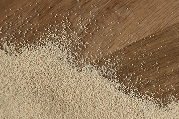Dry yeast scattered on wooden surface, copy place for text.