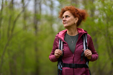 Hiker looking around in forest