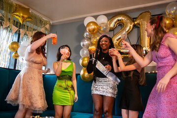 Group of female friends celebrating 21st birthday