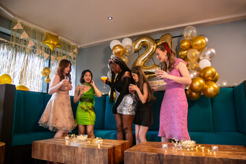 Group of female friends celebrating 21st birthday