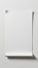 Blank white poster taped on a white wall with curled bottom edge