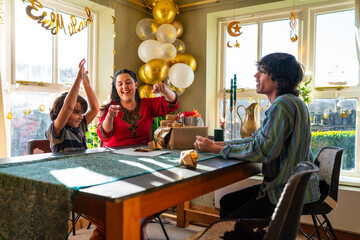 Adult siblings with little sister preparing gifts for Eid Celebration