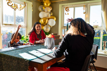 Mother with two daughters preparing gifts for Eid Celebration