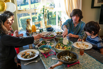 Mother and three children dining during Eid Celebration