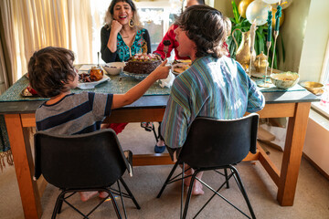 Mother with three children dining during Eid Celebration