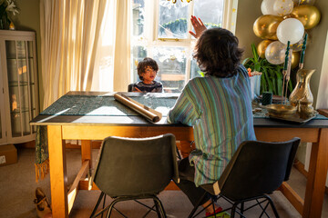 Fototapeta premium Young men with little sister preparing gifts for Eid Celebration