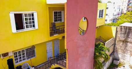 Yellow buildings architecture hotels apartments palm Playa del Carmen Mexico.