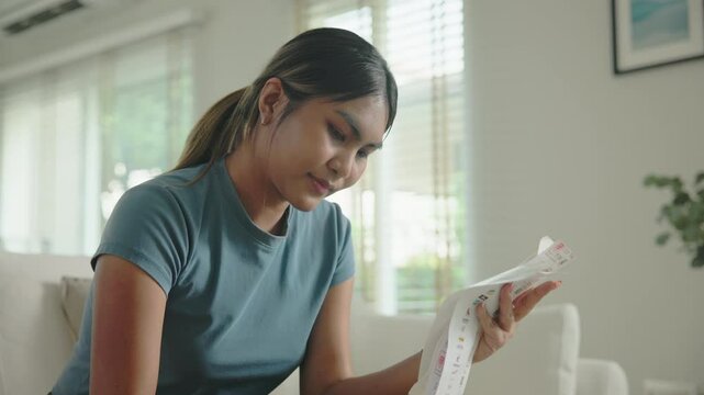 Cost of living income expense saving budget in black asia people Gen Z young adult woman. Looking credit card bill debt home loan money paying happy asian female healthy wealth care goal plan tracking