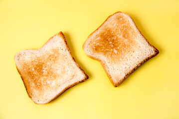 Toasted bread on a yellow background is a set of sliced slices of toasted bread highlighted on a white background.