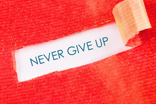 Naklejki Business development challenge concept and effort success idea. Never give up written under a piece of torn paper
