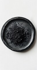 Black powder on dark plate.