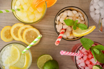 Several glasses with soft drinks of different flavors top view