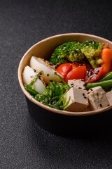 Vegan salad, bowls with chickpeas, broccoli, tomatoes, tofu cheese and boiled eggs