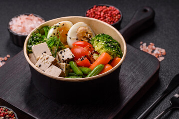 Vegan salad, bowls with chickpeas, broccoli, tomatoes, tofu cheese and boiled eggs