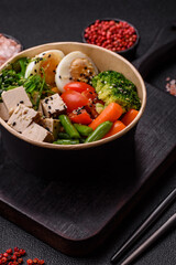 Vegan salad, bowls with chickpeas, broccoli, tomatoes, tofu cheese and boiled eggs