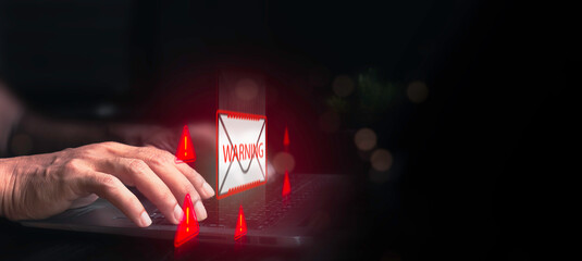 Businessman using laptop with virtual screen icon represent Scam, Fraud alert, Cyber attack network, Virus, Spyware, Malware, Malicious software. Cyber security and cybercrime concept.