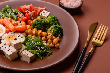 Vegan salad, bowls with chickpeas, broccoli, tomatoes, tofu cheese and boiled eggs