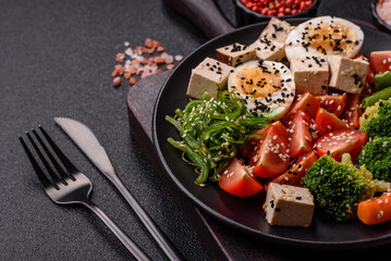 Vegan salad, bowls with chickpeas, broccoli, tomatoes, tofu cheese and boiled eggs