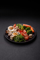 Vegan salad, bowls with chickpeas, broccoli, tomatoes, tofu cheese and boiled eggs