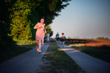 Joyful Girl Running on Country Path at Sunset