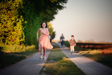 Joyful Girl Running on Country Path at Sunset