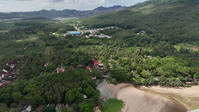 Aerial drone view of red island east java indonesia tropical beach surfers ocean waves
