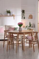 Stylish dining table with chairs in room. Interior design