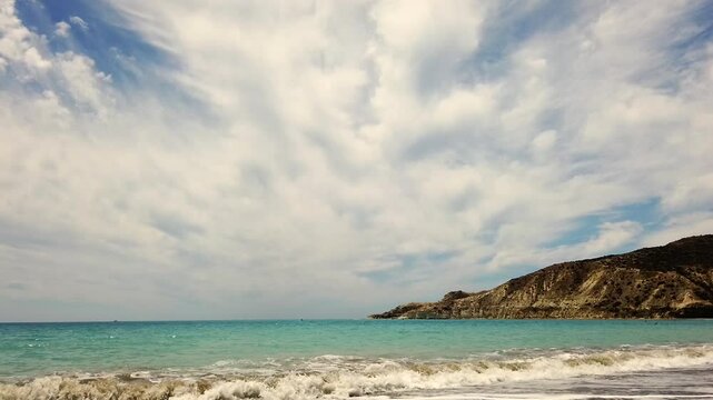 Open water view from Pissouri Beach, Cyprus. Choppy waves meet the shore under a cloudy sky, capturing the beauty of the Mediterranean Sea. Ideal for travel, nature, and scenic themes.