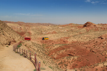 Beautiful landscape of Pingshan Hu Grand Canyon with the SUV car and mini bus in summer, Zhangye City, Gansu Province in China