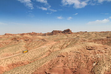 SUV car moving on dusty road at Pingshan Hu Grand Canyon in summer, Zhangye City, Gansu Province in China