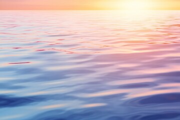 Calm water surface reflecting soft colors of sunset scenery