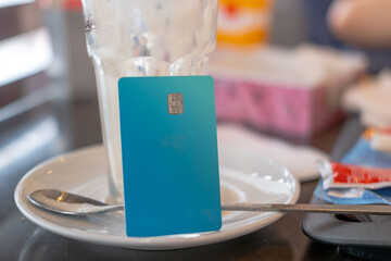 blue payment card on saucer, payment or tipping concept, Financial transaction in dining setting, service industry, modern banking