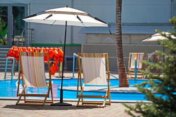 Almaty, Kazakhstan - 05.22.2025 : Lounge chairs on the background of the pool.