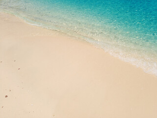 Clear blue sea and sandy beach on a sunny and clear day. Beautiful nature image for holiday travel