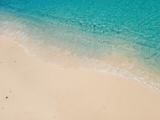 Clear blue sea and sandy beach on a bright and sunny day. Beautiful nature scenery for a holiday trip.