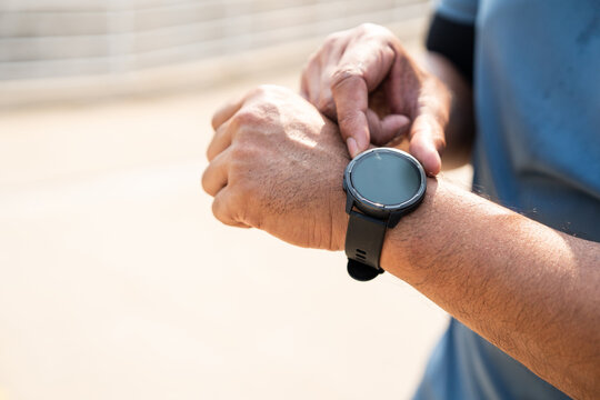 Mature man wearing sportswear using Smart Watch Showing Heart Rate Monitor. Old man with Technology for health and sport mode. Exercise and take statistics to develop your potential