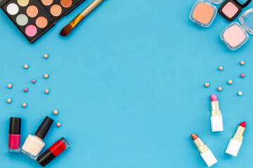 Frame of various makeup tools and cosmetics products, top view