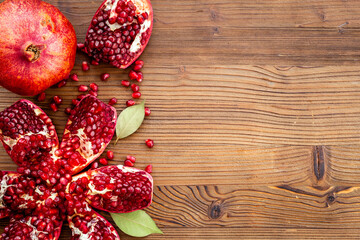 Top view of fresh ripe pomegranate with half and pieces ready for eating