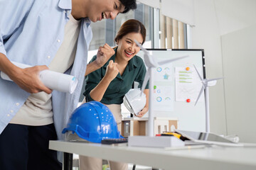 Collaboration and Innovation. Young engineers discussing renewable energy projects in office.