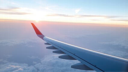 Obraz premium A stunning view from an airplane window showing the wing against a backdrop of fluffy clouds and a vibrant sunrise. Generative, AI,