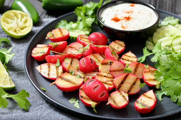 grilled radishes with cucumber slices and sauce