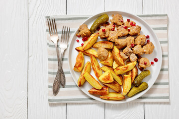 meatballs, potatoes, pickles, berries on a plate