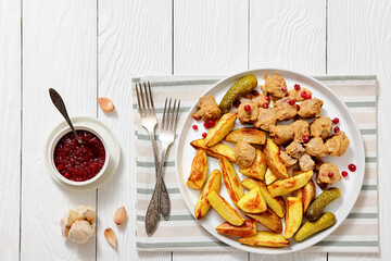 meatballs, potatoes, pickles, berries on a plate