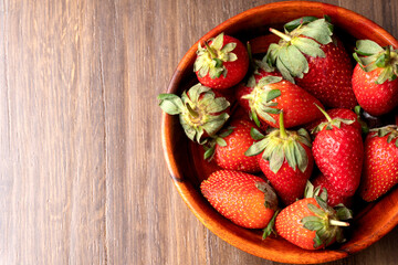 Fresh and Juicy beautiful organic strawberries on wooden background. Top view point.