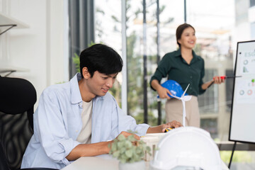 Obraz premium Collaboration in Sustainable Design. Professionals discussing renewable energy solutions in a modern office.