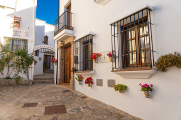 Street of the beautiful white village of Parauta in the Ronda mountains at sunset. Malaga province, Andalucia, Spain.