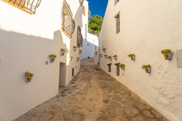 Street of the beautiful white village of Parauta in the Ronda mountains at sunset. Malaga province, Andalucia, Spain.