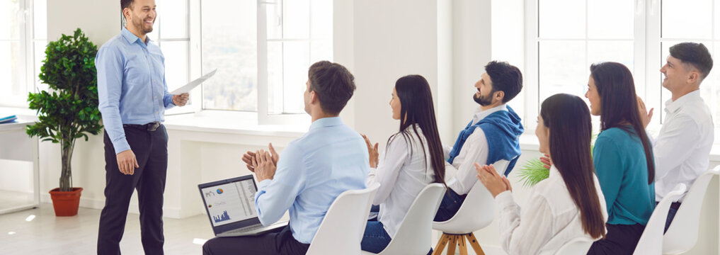 Business coach giving presentation for new company staff, group of professionals gathered in conference room engaged in educational briefing, formal meeting event, seminar training, brainstorm ideas