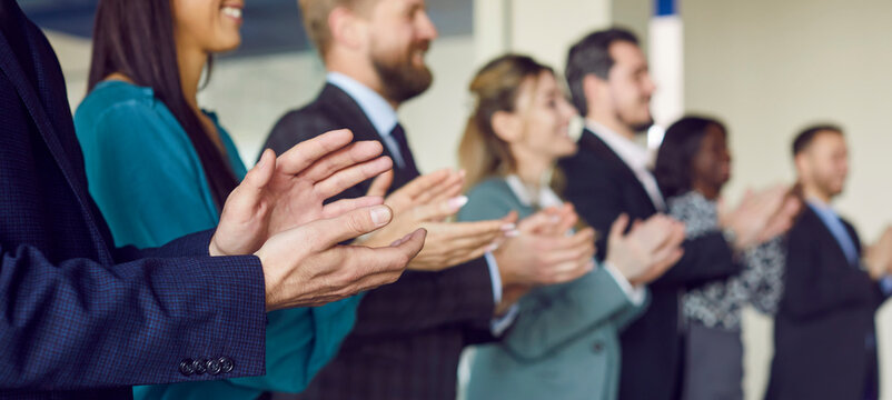 Employees close up applauding, thanking, excited mature team after good presentation or training at corporate meeting, business people celebrating success, celebrating good news corporate success